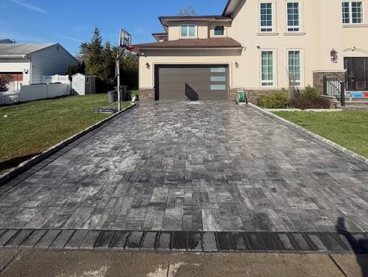 Completed gray paver driveway installation.